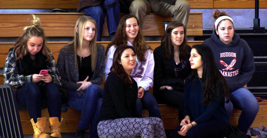 A group of Hudson High Gymnastic Team alumni watching the team compete. 