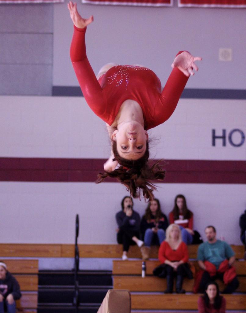 Maddie Grasso dismounts from the beam in a back tuck.