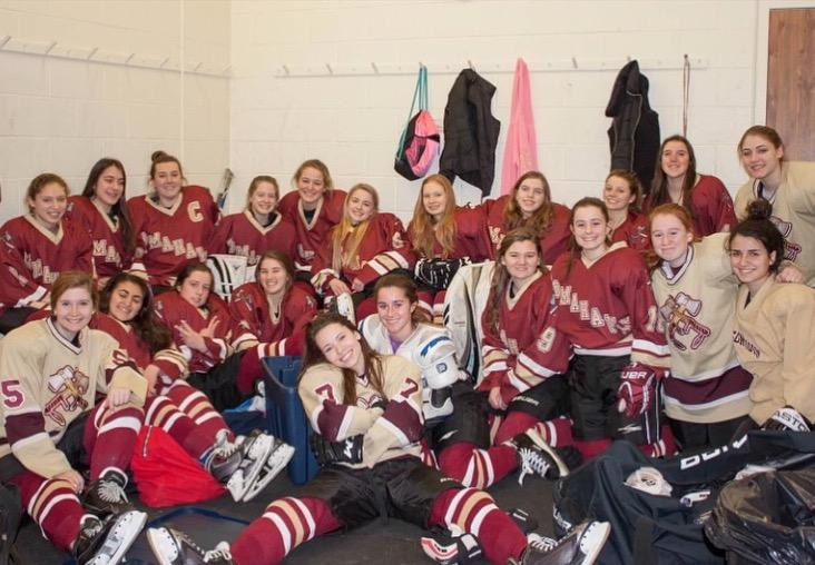 The girls ice hockey team poses for a picture before a practice.| by Tracy Ferro 
