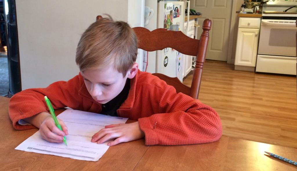 Third grade student, Gavin Capobianco works on a homework assignment preparing him for MCAS. | by Dakota Antelman