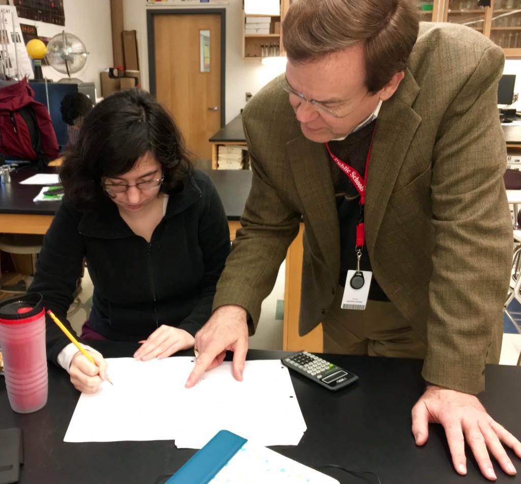 by Allison Vickery | Reed helping a student with her physics work. 