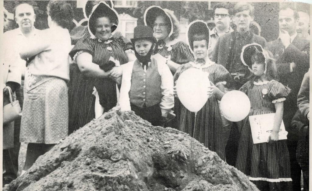 This photograph of the time capsule burial in 1966, shows Rita Patterson (left), and Betty Brandie (right). Both women were den mothers who helped the Boy Scouts and Girl Scouts in the photo to create clothes similar to those in 1866. The two girls are from the class of 1978, and the boy is from the class of 1972. Patterson is also the mother of the boy and the girl on the right. | photograph and information supplied by John McClellan.