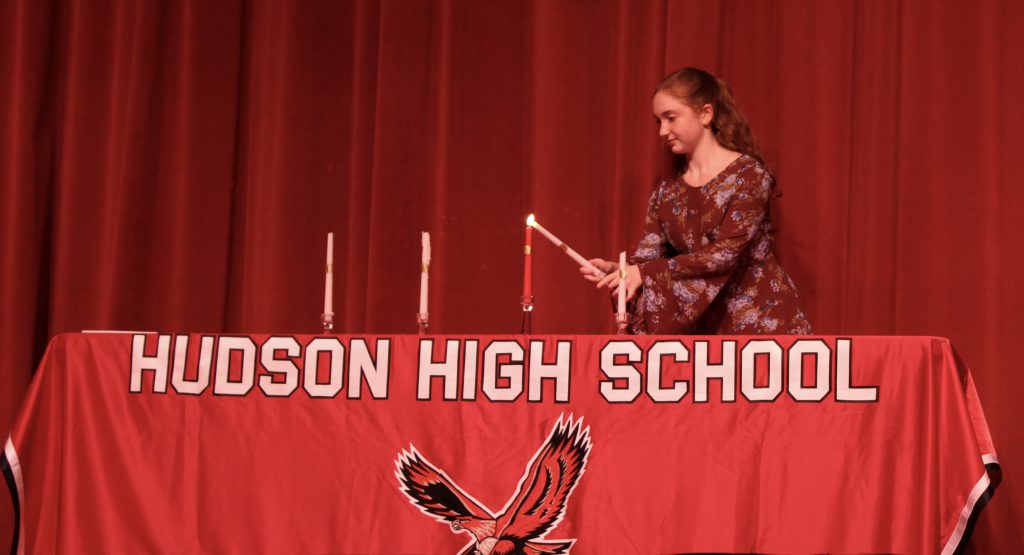 NJHS President Maya Levine lights the candle of Scholarship, one of the core values of NHS. | by Siobhan Richards 