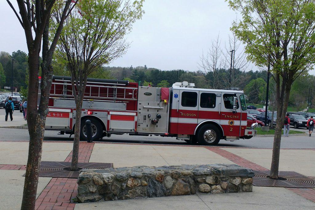 A Hudson firetruck waits outside Hudson High School as students leave after dismissal. The last of the firetrucks to respond to HHS left shortly after 2pm. | by Dakota Antelman