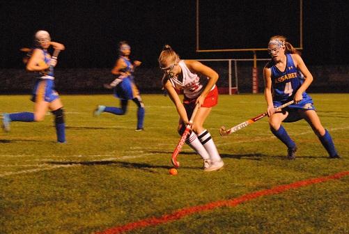 Emily White rushes past Assabet defenders with the ball early in the first half. | by Dakota Antelman