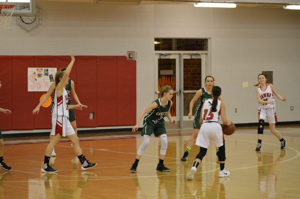 Alex Sousa looks for someone open while being covered by 2 Grafton players.  | by Maggie OBrien
