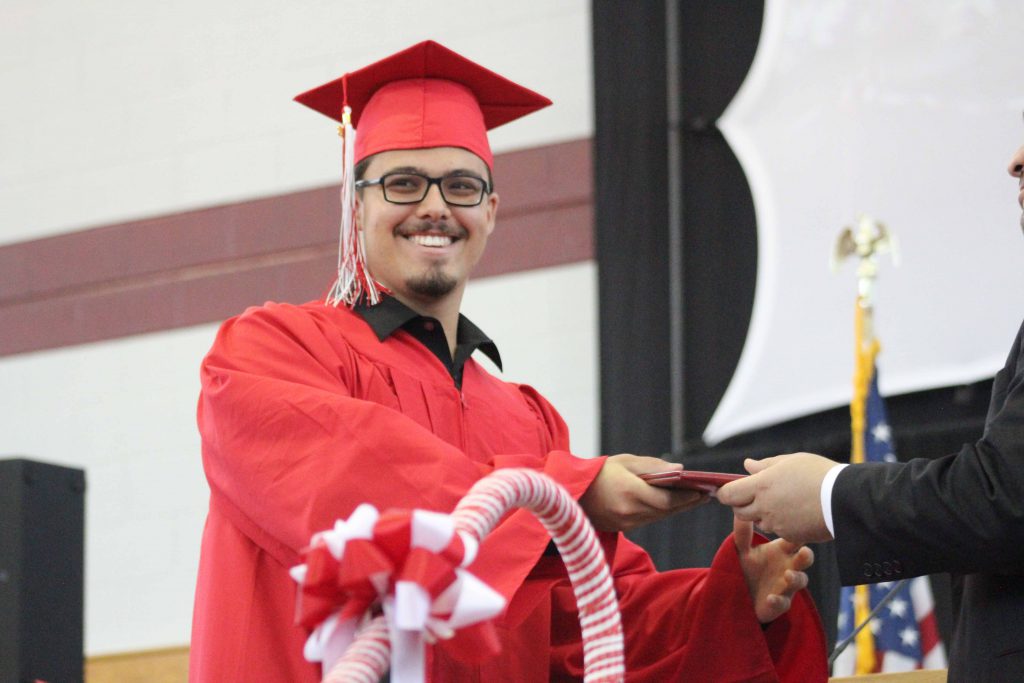 Nicholas Bassetti receives his diploma.  |by Ally Jensen

