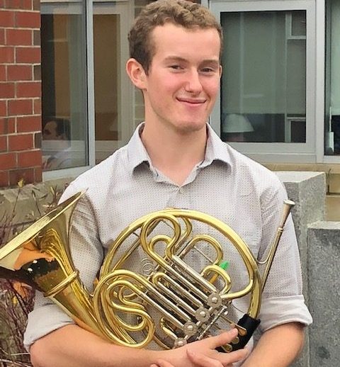 Sean Morton holds his French Horn. | Photo Courtesy of Jason Caron