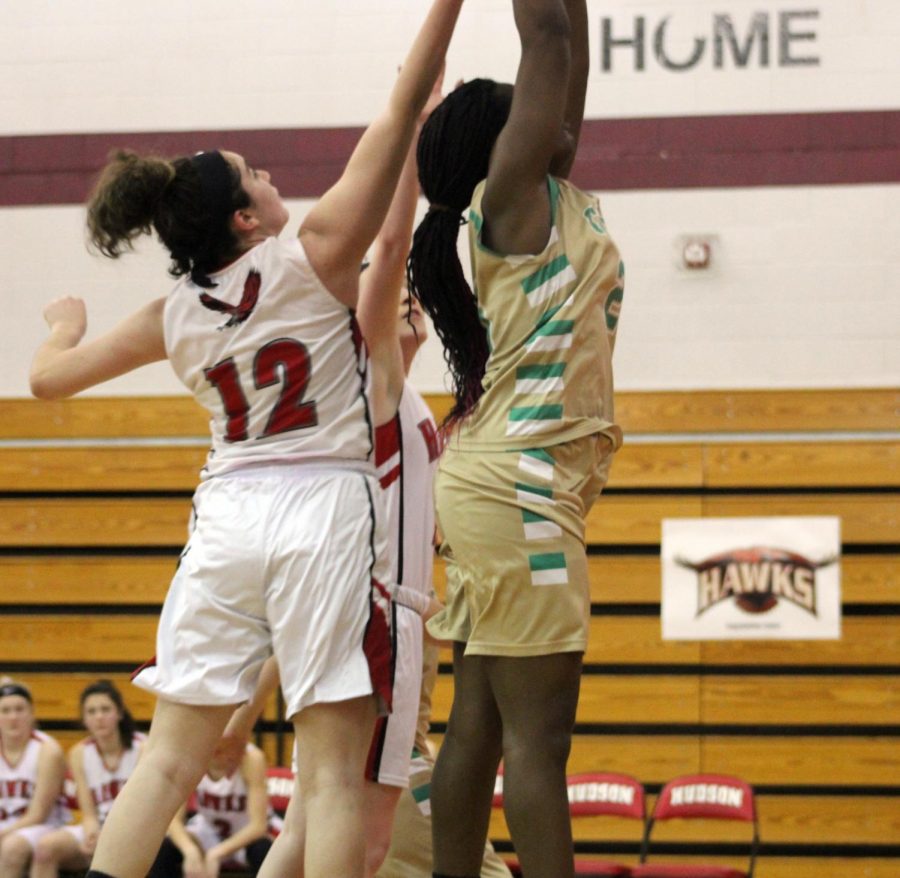 Senior Allura Carney (12) jumps for the rebound after missed shot by Clinton | by Audrey De Zutter  