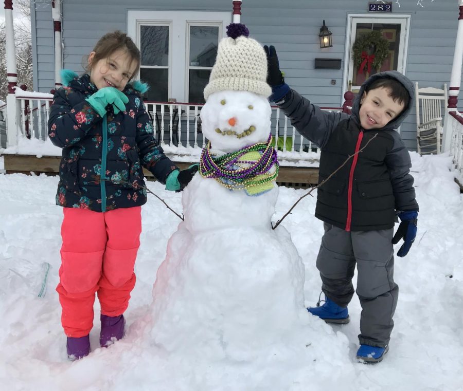 English Teacher Amy Plackowskis children Myka and Asher with Fred, the Mardi Gras Snowman hamming it up.