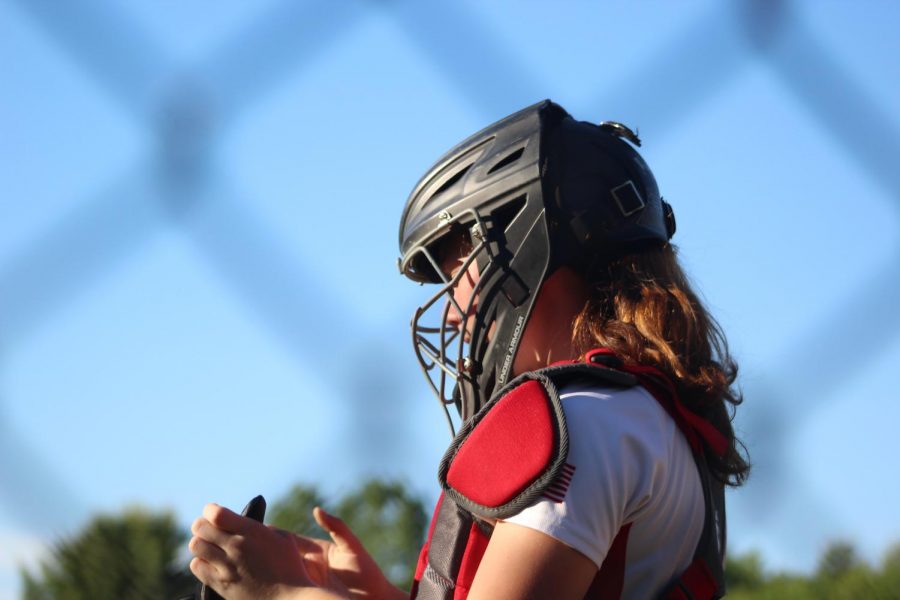 Catcher, Caitlin Cassidy (4) preparing for the game |by Brianna Devlin