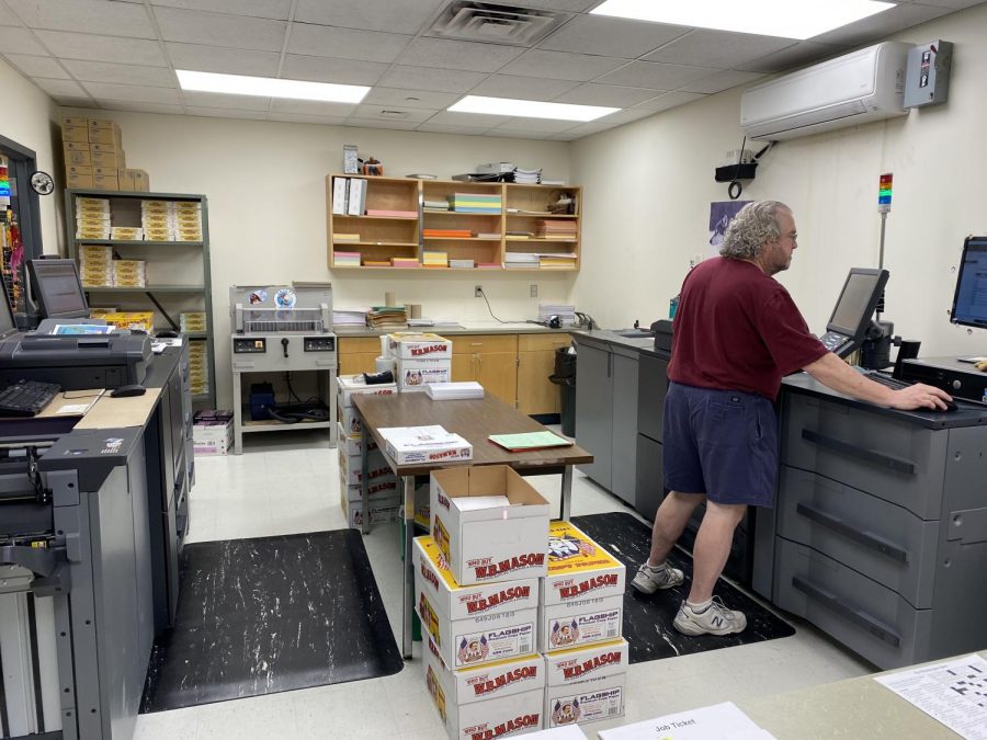 Scott Burnham helps some staff out by printing handouts. Students and staff use the copy center daily