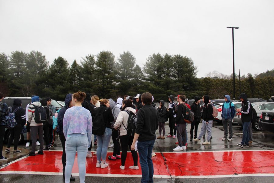 Students stand in solidarity after leaving the school