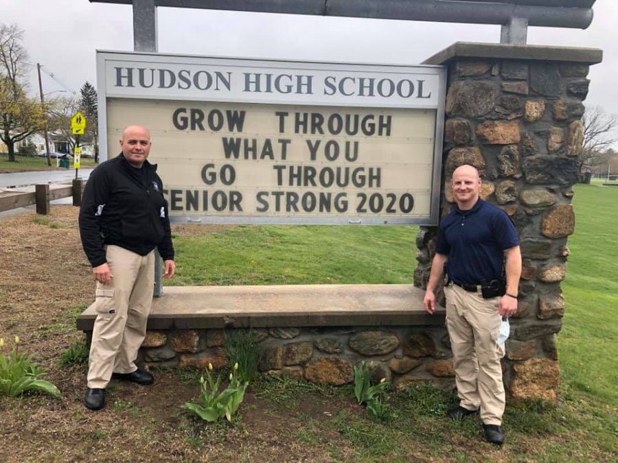 Hudson Police School Resource Officers Detective Chad Crogan and Detective Seamus Veo stand in front of their updated sign at HHS | photo provided by Hudson Police Department