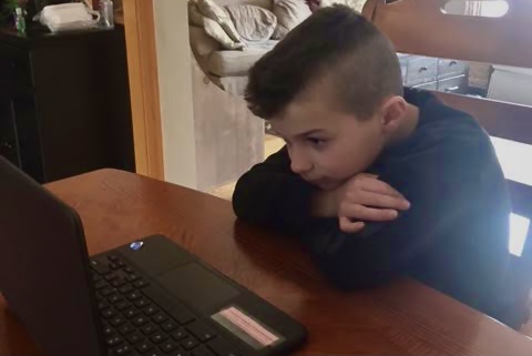 Second-grader Jacob Hermann studies during online classes | Photo Courtesy of Stephanie Hermann