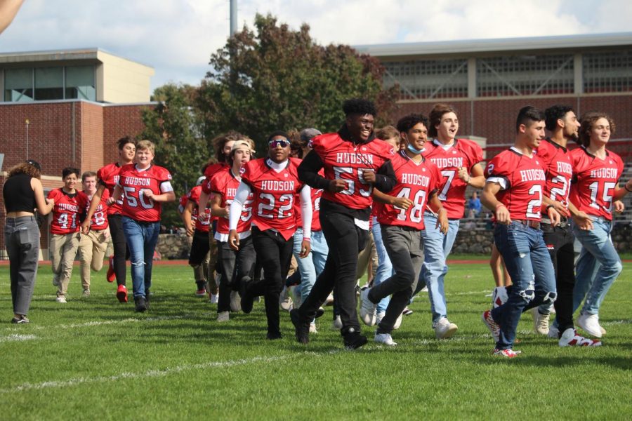 Varsity Football running out to the field |by Ella Spuria