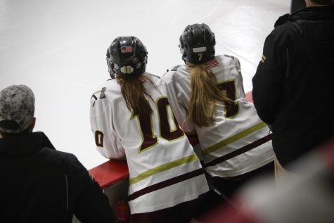 Emanuelle Fernandes (10) and Mallory Farrell (7) watching game |by Brianna Devlin