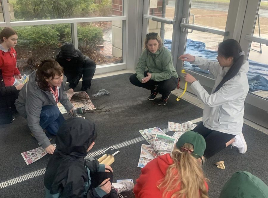 The tree plenish group escapes the rain to get organized for the event| provided by HHS Environmental Club Instagram
