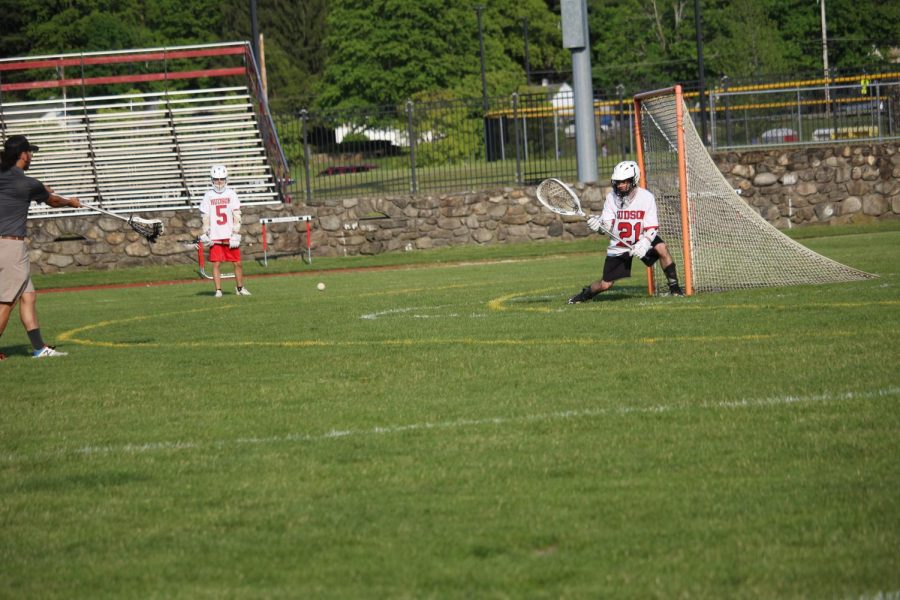 Goalie Issac Ladas warming up with Assistant coach Lucas Ando 