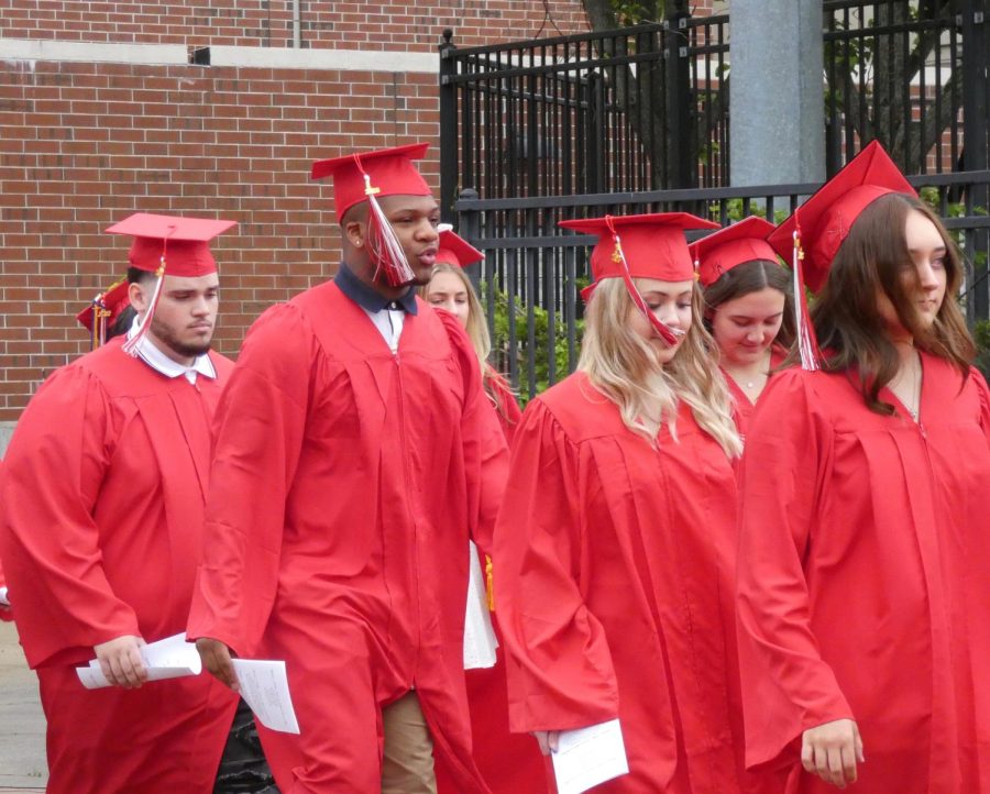 Graduates walking from the school to their seats | Alex Cutler