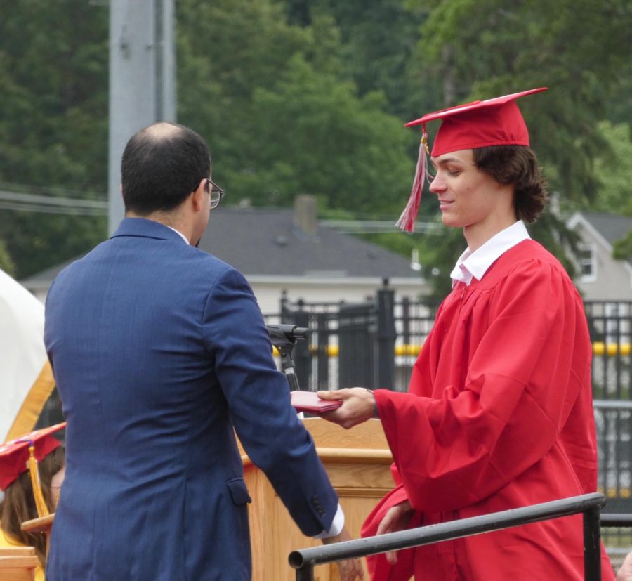 Tanner Cutler receiving diploma from Dr. Medeiros | Alex Cutler 