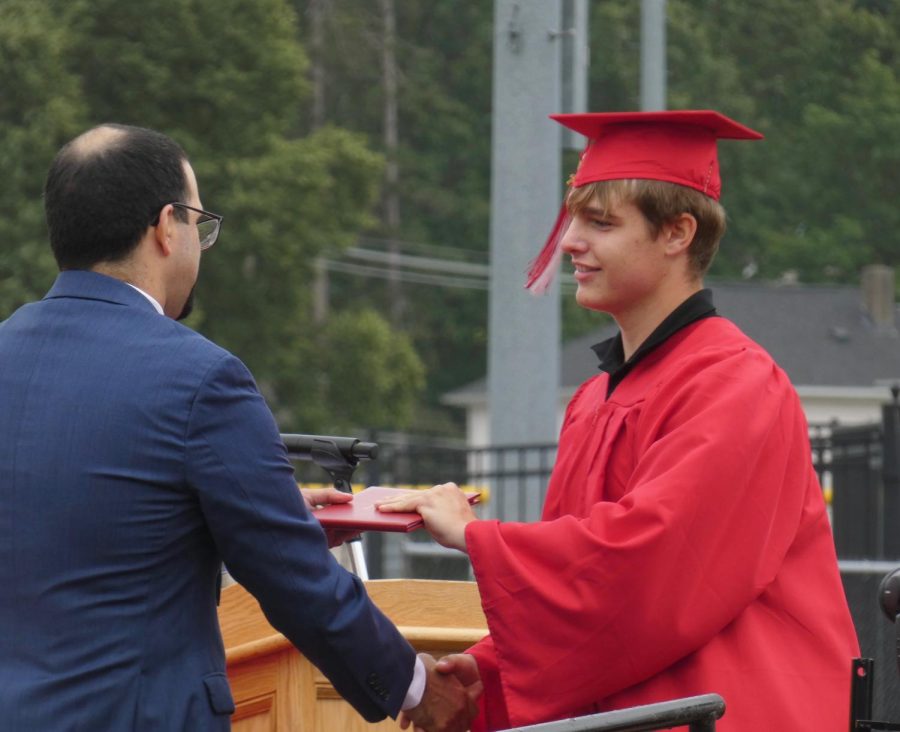 Grayson MacDonald receiving diploma from Dr. Medeiros | Alex Cutler