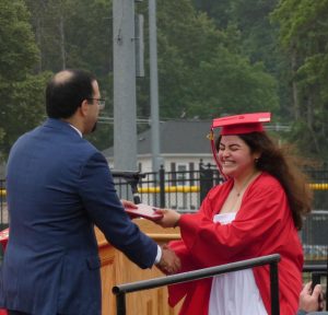 Camille Souza receiving diploma from Dr. Medeiros | Alex Cutler