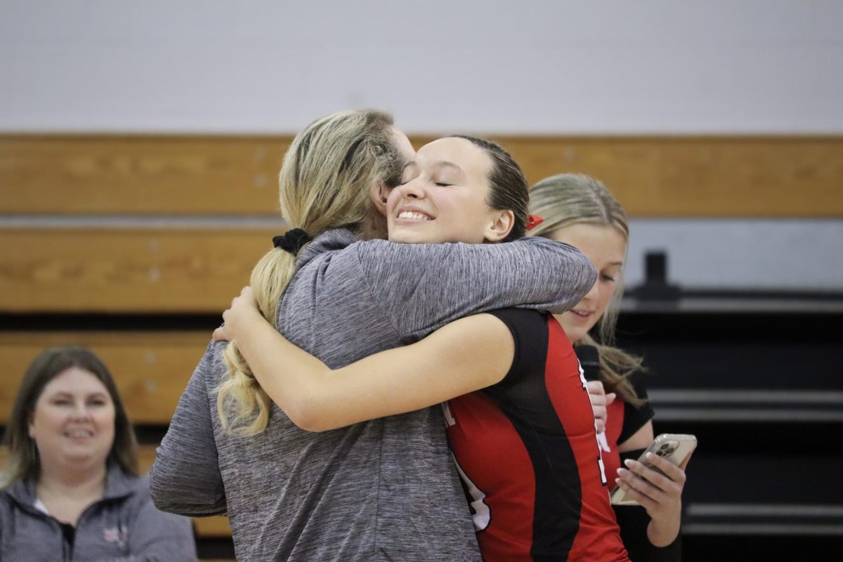 Senior Kelsie Figueiredo (10) hugs her coach |by Ella Spuria