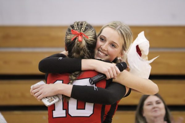 Jenn Yates (11) and senior Kelsie Figueiredo (10) hug it out |by Ella Spuria