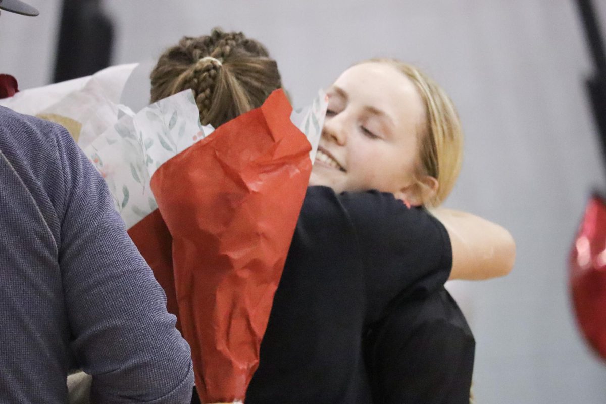 Captain Addison Murphy (1) hugs her teammate goodbye |by Ella Spuria
