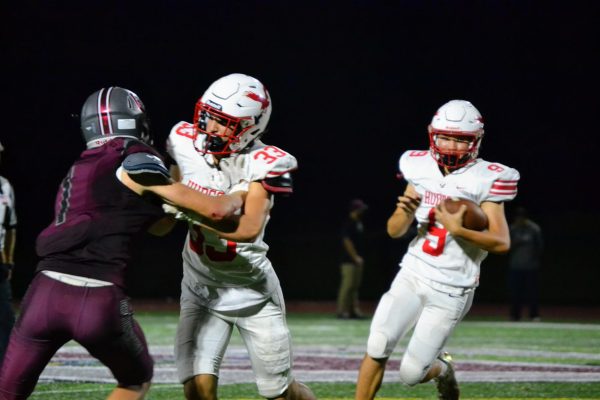 Lorenzo Caputo (33) blocking for Roy Gao (9) | by Jason Ford