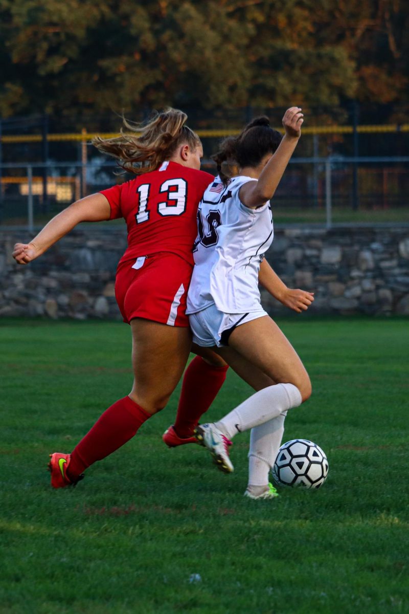 Lauren OMalley (13) fighting for the ball |by Ella Spuria