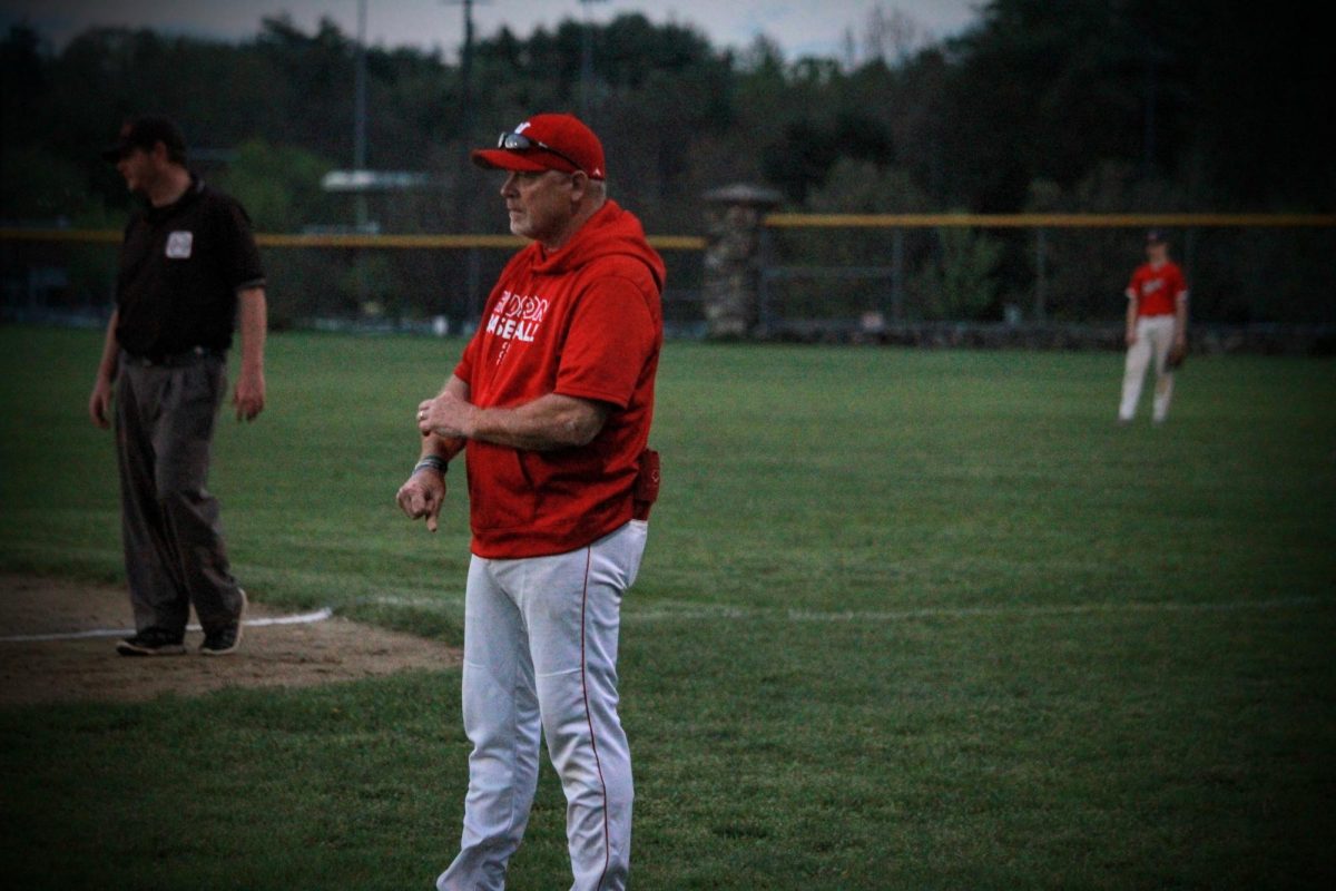 Assistant Coach Mike Nanartowich coaching at first base line |by Andrew Oliveira  