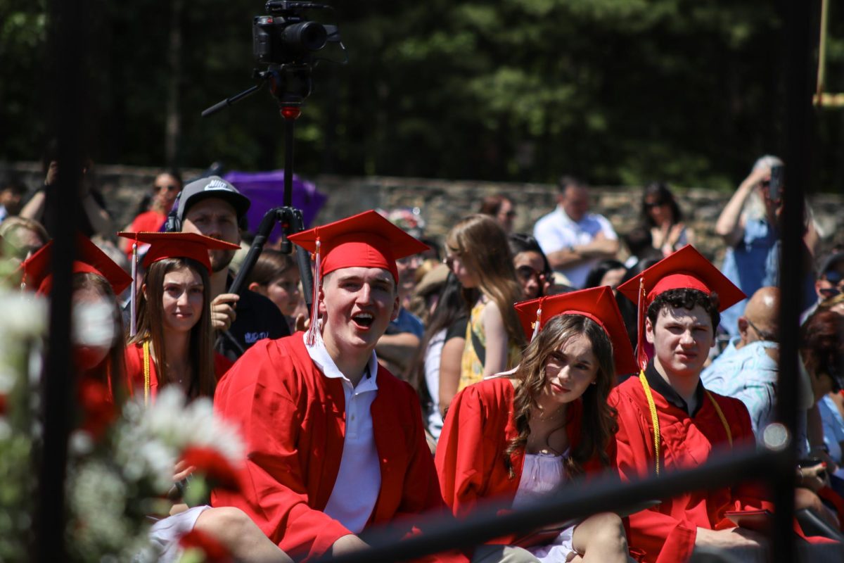 Classmates each other on as they collect their diplomas |by Ella Spuria