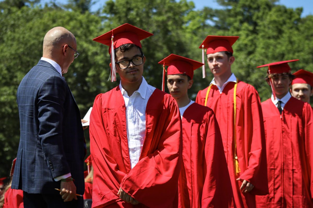 The first row of seniors line up to walk the stage |by Ella Spuria