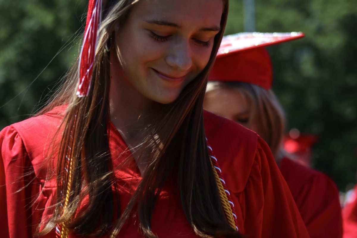 Girls Varsity Track Captain and Co-Editor-in-Chief of the Big Red Olivia Downin about to walk the stage |by Ella Spuria