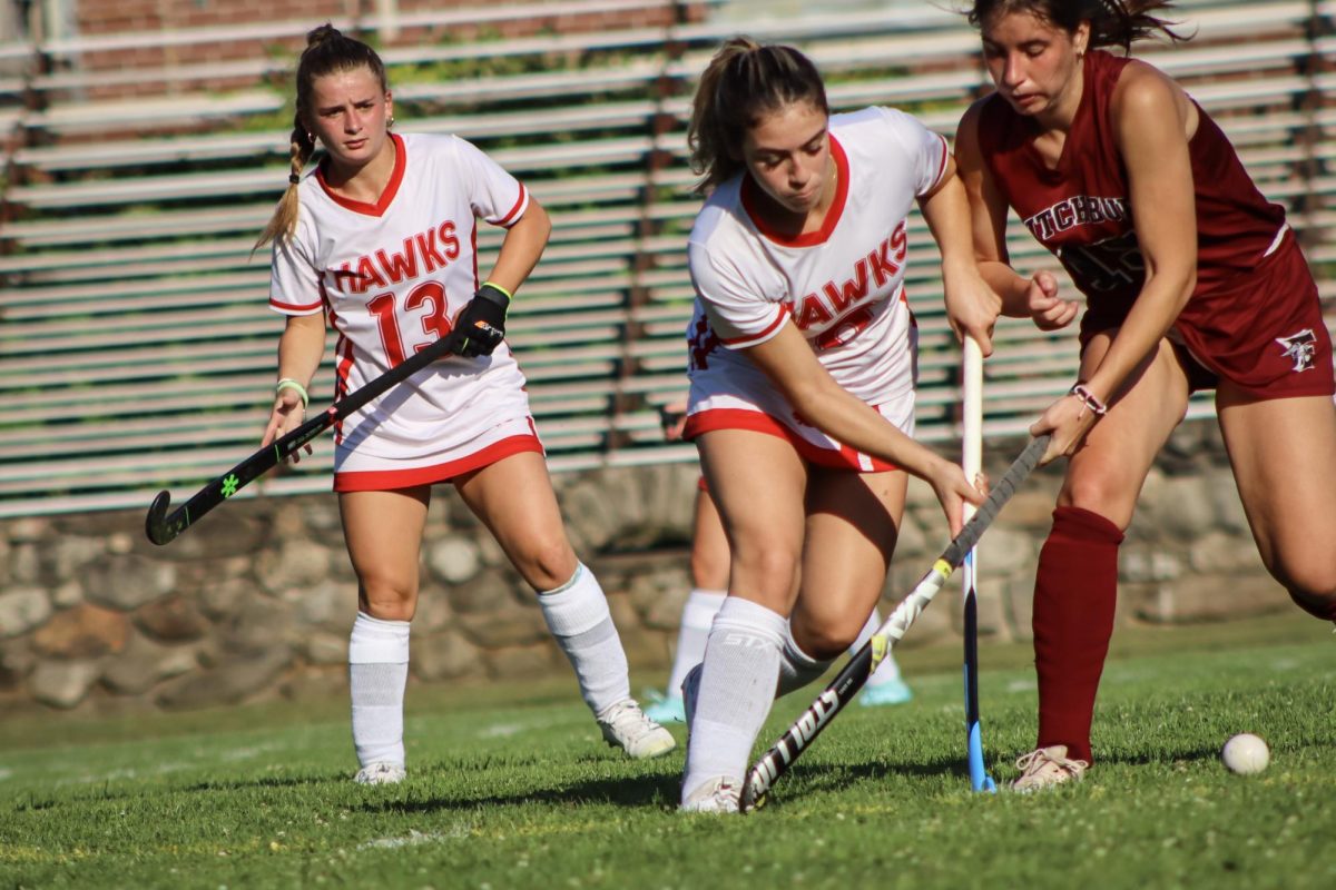 Liv Connolly (13) watches as Hannah Cruciol (8) fights for possession from Fitchburg | by Ella Spuria