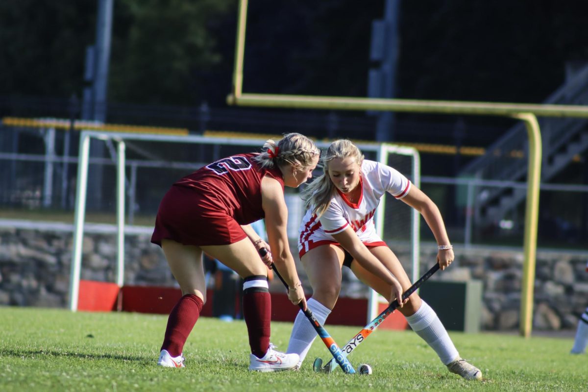 Lilly Fistori (21) fights for possession from Fitchburg |by Ella Spuria