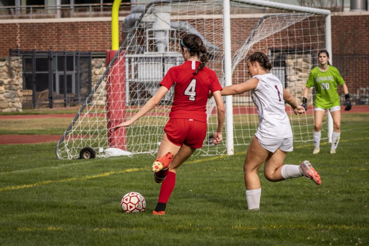 Captain Maddie Haher (4) goes in for the goal |by Ella Spuria