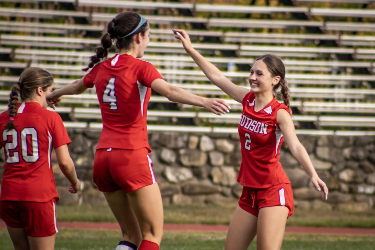 Mackenna McGuire (2) gives Captain Maddie Haher (4) a hug after her goal |by Ella Spuria