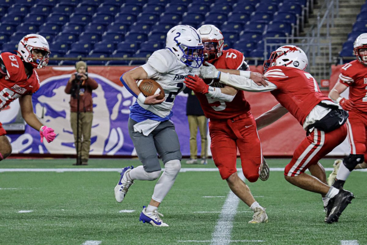 Fairhaven, in possession, attempts to make it through Hudson defense, Captain Owen Nanartowich (5) and Tyrese Meuse (7) |by Ella Spuria