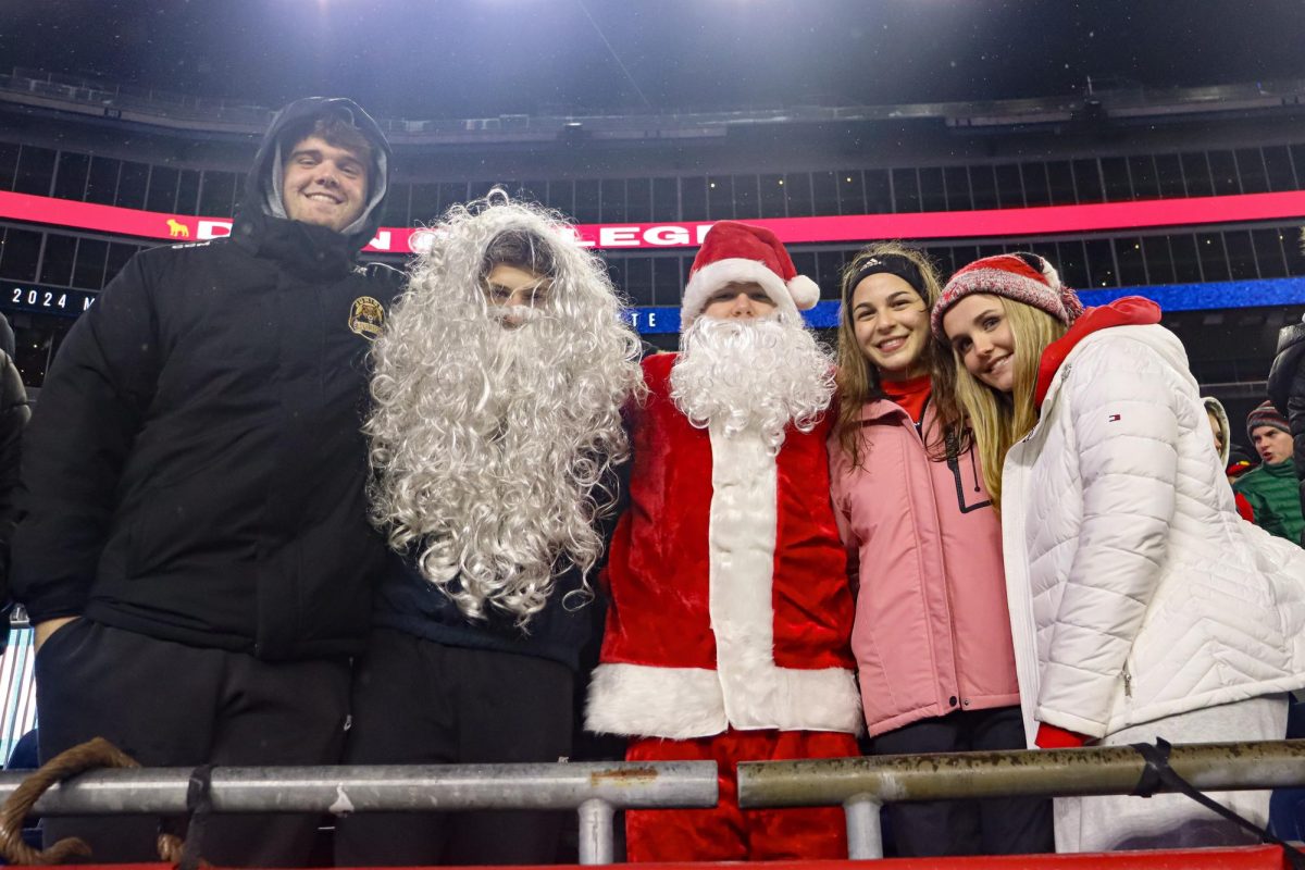 Red Sea Leaders Sean Foley, Braeden Murphy, Ben Hillis, Rachel Costa, and Lauren O'Malley lead the student section |by Ella Spuria