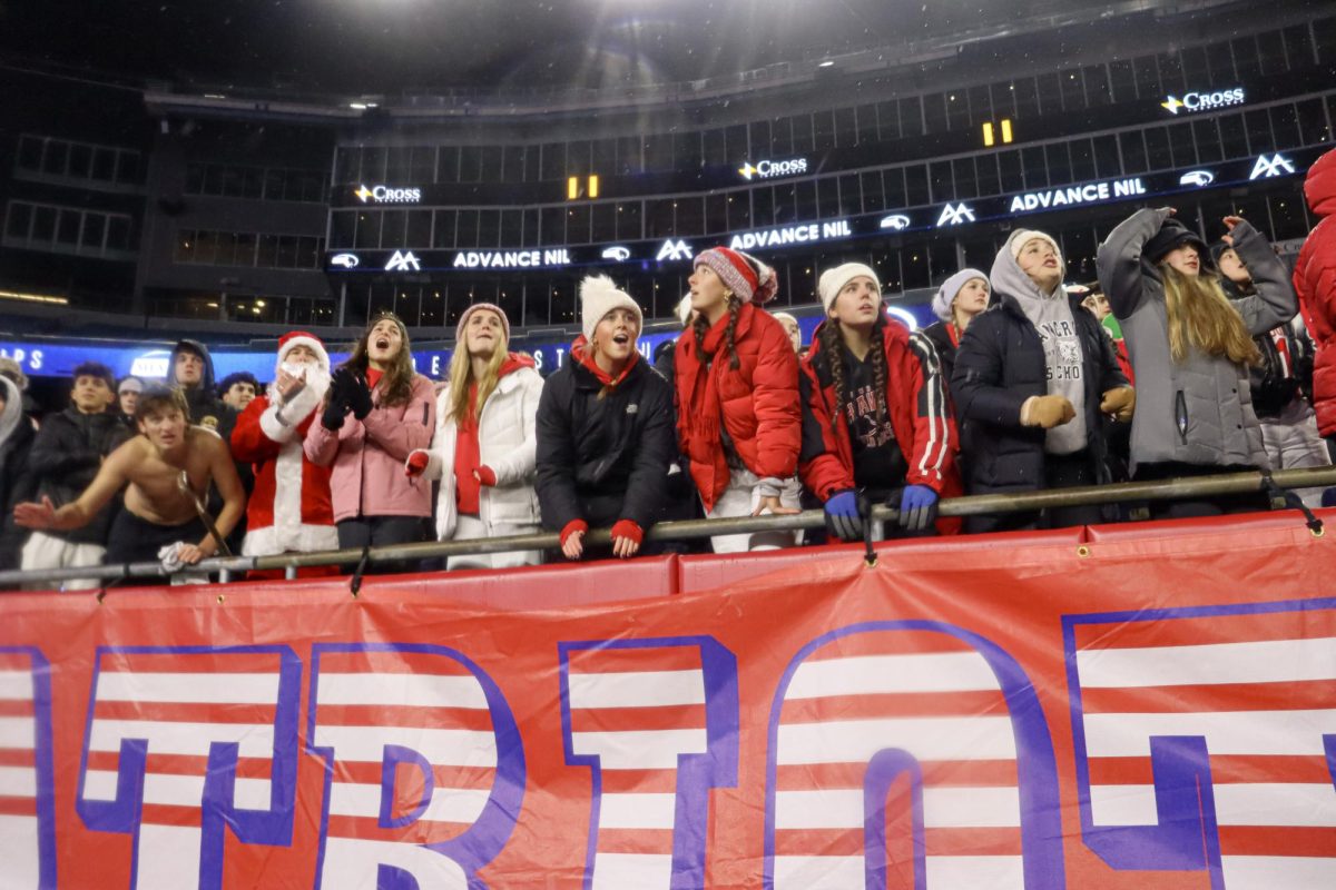 Spectators in the student section watch the play on the edge of their seats |by Ella Spuria