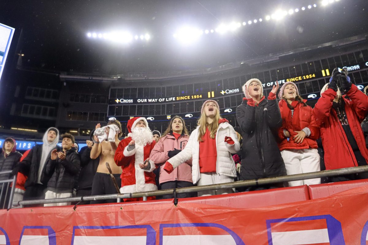 The front row of the student section watches the game from the stands |by Ella Spuria