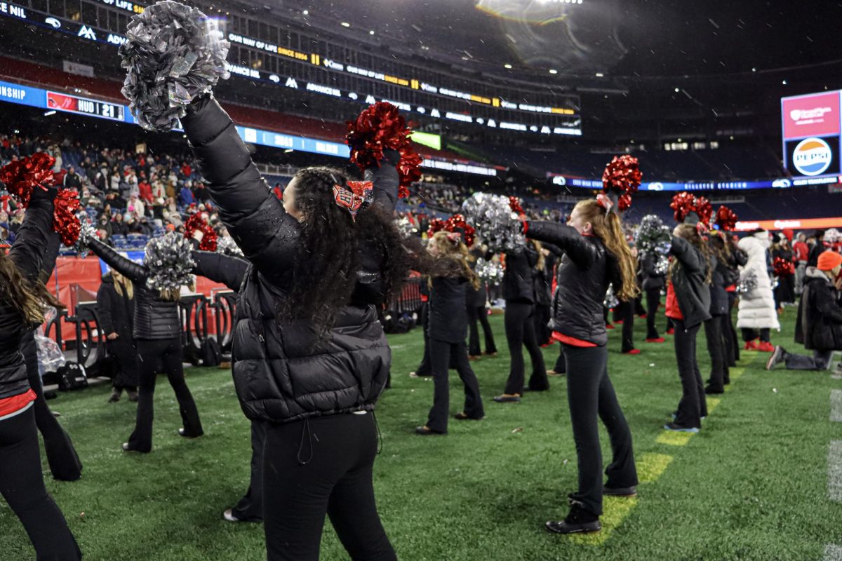 Varsity Cheerleading gets the crowd loud going into the final quarter |by Ella Spuria