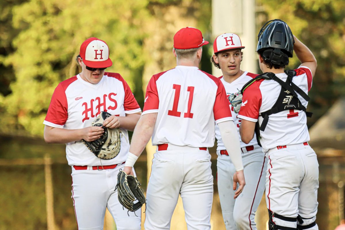 Team huddle on the pitchers plate |by Ella Spuria