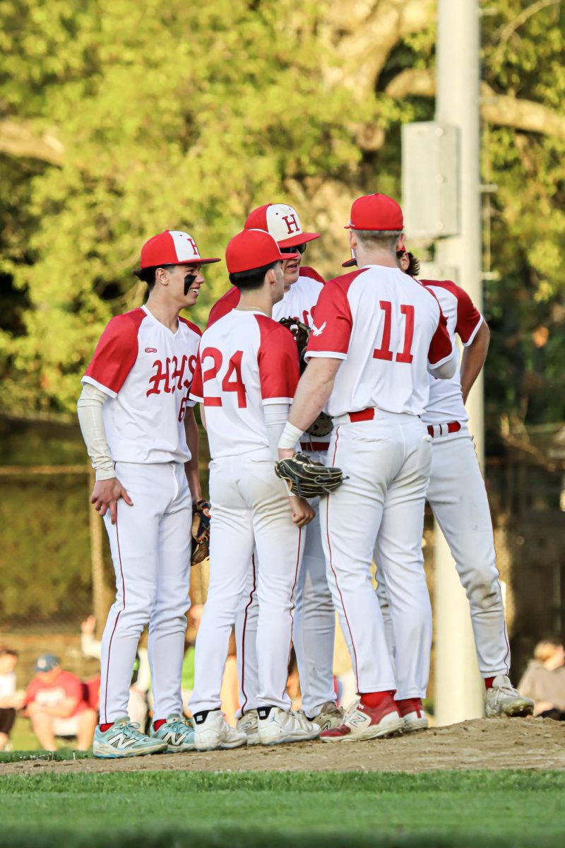 Team huddle on the pitchers plate |by Ella Spuria