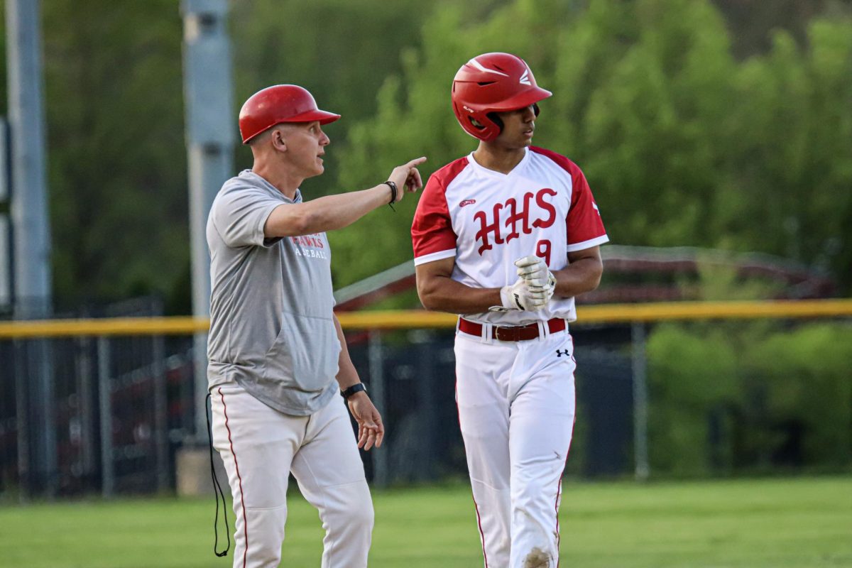 Captain Caelen O'Brien (9) and Coach Reinhardt at second |by Ella Spuria