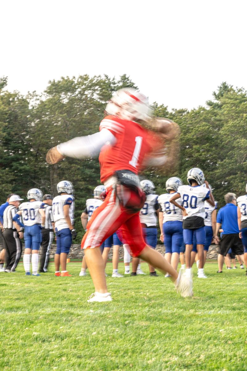 Quarterback Logan Dome warms up with players | by Caden Crogan
