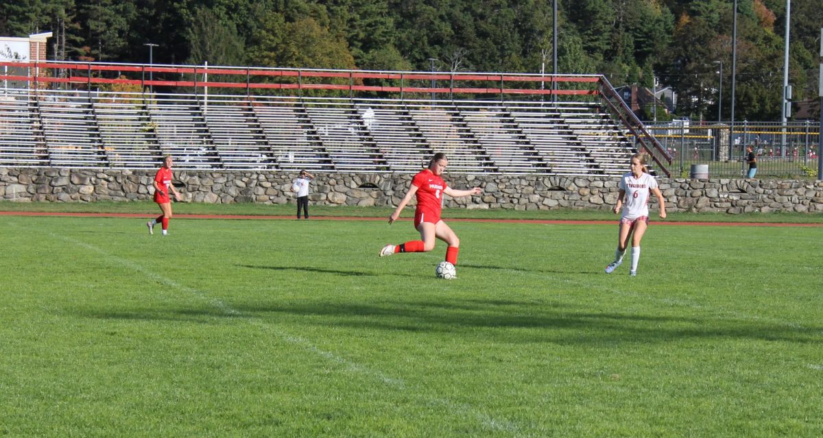 Freshman Melanie Person kicking the ball back towards Tyngsboro's goal. 